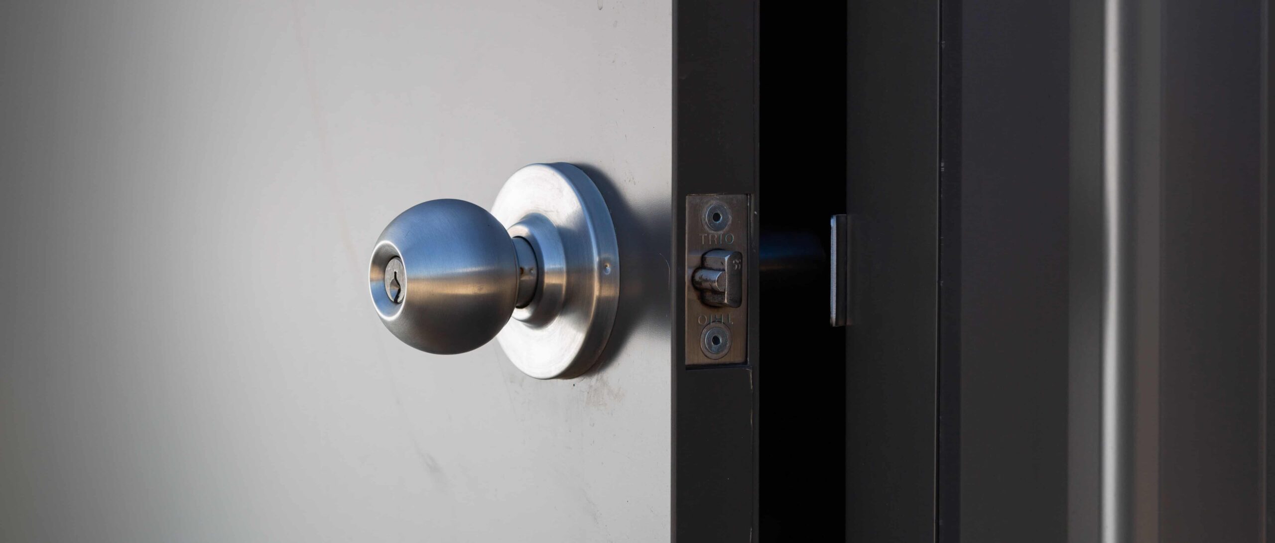 A stainless steel door handle on a weatherproof industrial door, ensuring durability and security in harsh environments