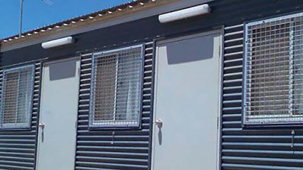 Portable doors installed in transportable buildings